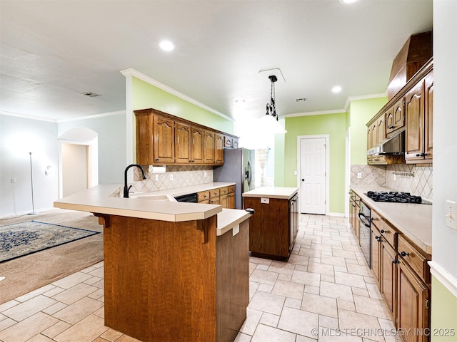 8704 N 140th E Ct, Owasso, OK 74055 - kitchen with a kitchen island, recessed lighting, black appliances, a breakfast bar area, and a peninsula