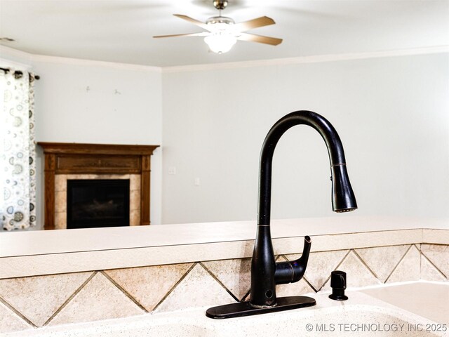 8704 N 140th E Ct, Owasso, OK 74055 - kitchen view of crown molding, a sink, and a tiled fireplace