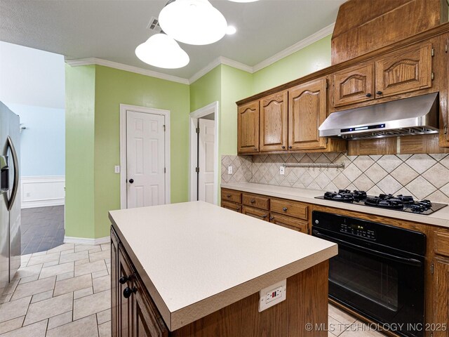 8704 N 140th E Ct, Owasso, OK 74055 - kitchen with black appliances, under cabinet range hood, backsplash, light countertops, and crown molding