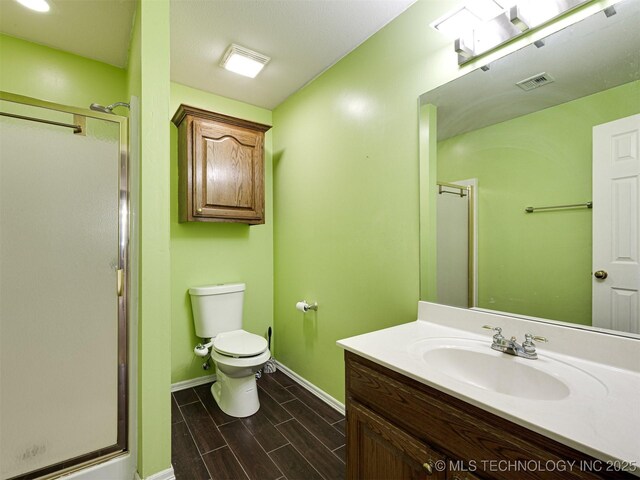 8704 N 140th E Ct, Owasso, OK 74055 - full bath with vanity, a stall shower, baseboards, toilet, and wood tiled floors