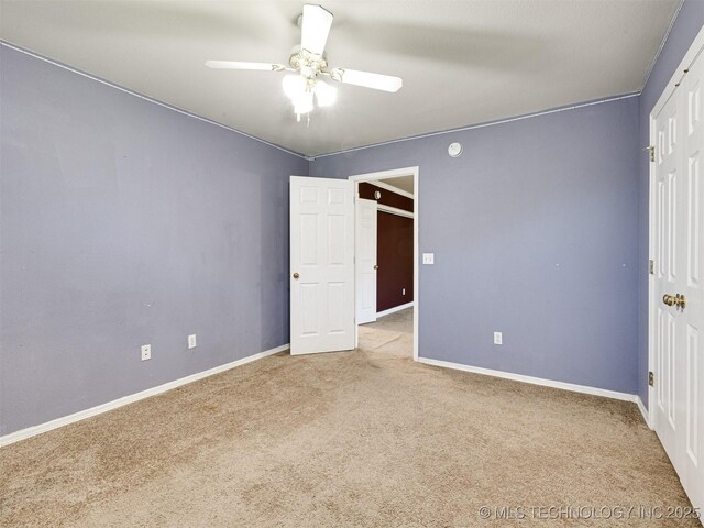 8704 N 140th E Ct, Owasso, OK 74055 - unfurnished bedroom with carpet flooring, baseboards, and ceiling fan