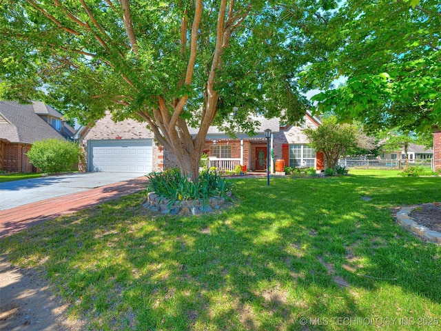 8704 N 140th E Ct, Owasso, OK 74055 - view of property hidden behind natural elements with brick siding, driveway, and covered porch