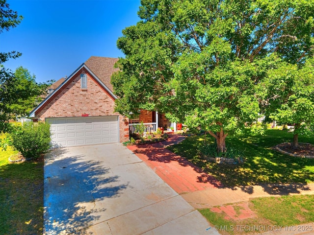 8704 N 140th E Ct, Owasso, OK 74055 - view of front of home featuring brick siding, driveway, a front lawn, and an attached garage