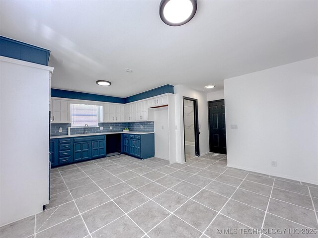 2212 W Independence Pl, Tulsa, OK 74127 - kitchen featuring blue cabinetry, a sink, light tile patterned floors, and light countertops