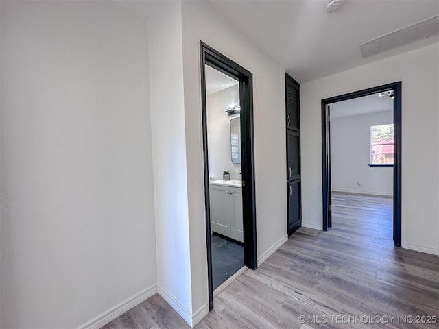 2212 W Independence Pl, Tulsa, OK 74127 - hallway featuring light wood-style flooring, baseboards, and a sink