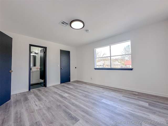 2212 W Independence Pl, Tulsa, OK 74127 - unfurnished bedroom featuring light wood-style floors, baseboards, and ensuite bathroom