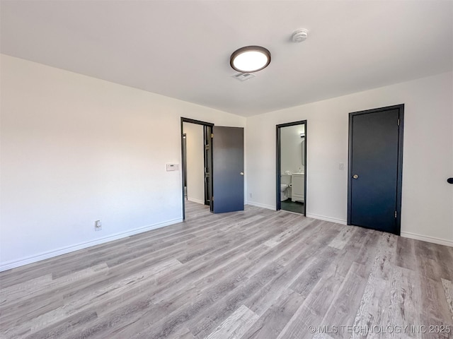 2212 W Independence Pl, Tulsa, OK 74127 - unfurnished bedroom featuring light wood-style floors, baseboards, and ensuite bath
