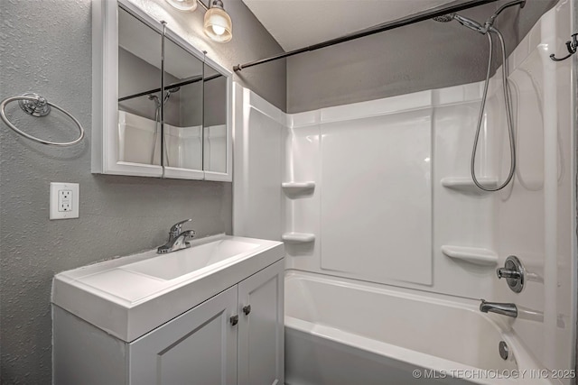 423 E Cherry St, Cushing, OK 74023 - bathroom featuring a textured wall, bathing tub / shower combination, and vanity