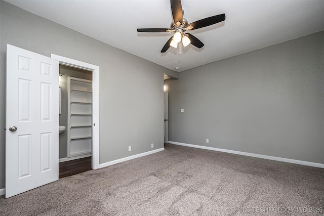 423 E Cherry St, Cushing, OK 74023 - unfurnished bedroom with carpet, baseboards, and a ceiling fan