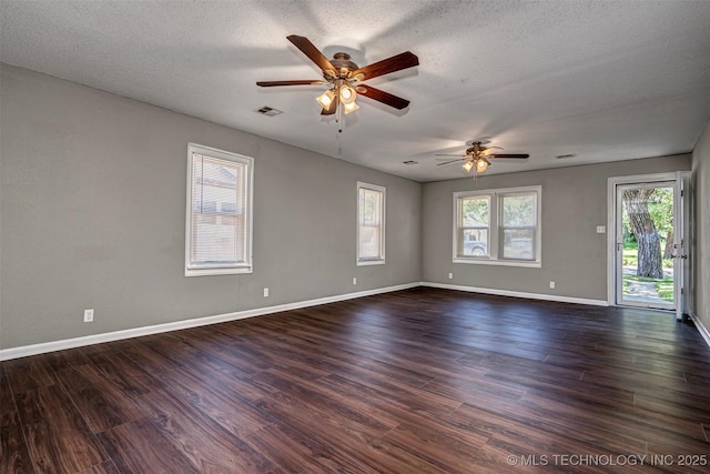 423 E Cherry St, Cushing, OK 74023 - unfurnished room featuring ceiling fan, dark wood-style flooring, a textured ceiling, and baseboards