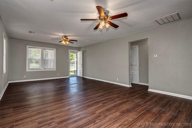 423 E Cherry St, Cushing, OK 74023 - spare room with a ceiling fan, dark wood-style floors, and baseboards