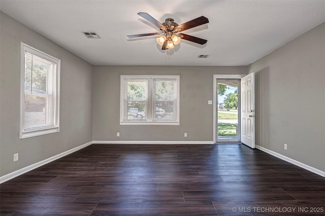 423 E Cherry St, Cushing, OK 74023 - unfurnished room with ceiling fan, baseboards, and dark wood-style flooring