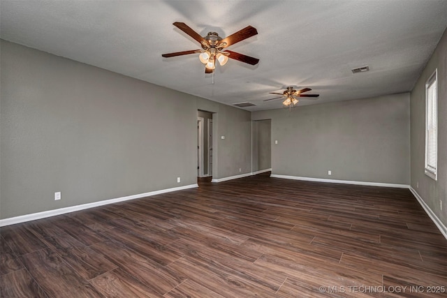 423 E Cherry St, Cushing, OK 74023 - spare room with ceiling fan, dark wood-style flooring, baseboards, and a textured ceiling