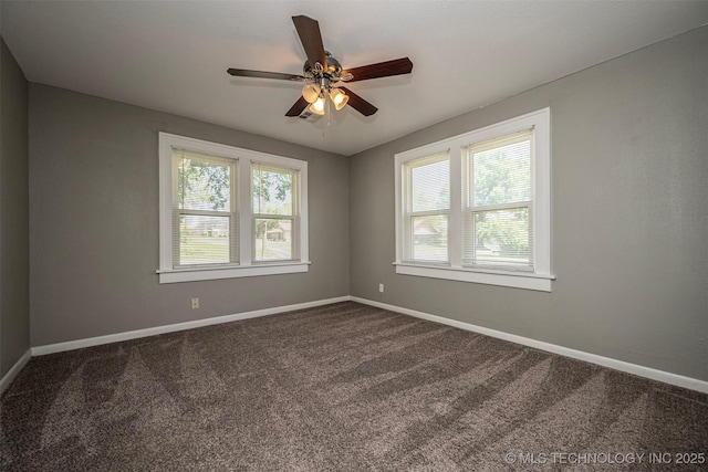 423 E Cherry St, Cushing, OK 74023 - spare room with dark carpet, a ceiling fan, and baseboards