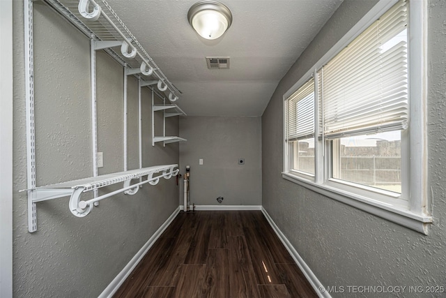 423 E Cherry St, Cushing, OK 74023 - laundry room with electric dryer hookup, wood finished floors, baseboards, and a textured wall