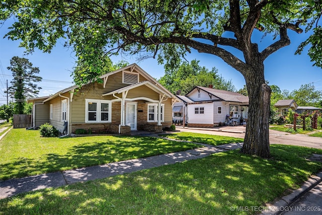 423 E Cherry St, Cushing, OK 74023 - view of front of property with stone siding and a front yard