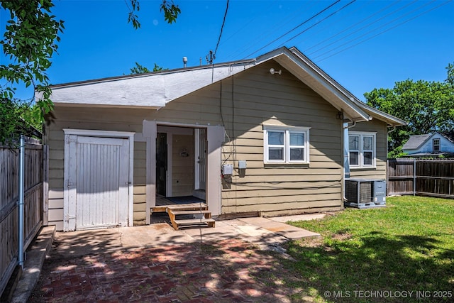 423 E Cherry St, Cushing, OK 74023 - back of property with central air condition unit