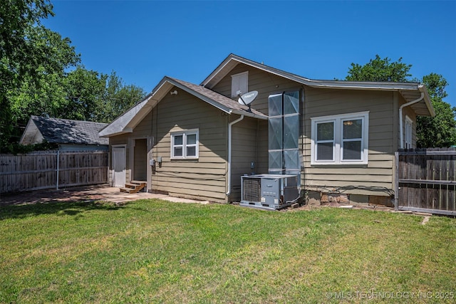 423 E Cherry St, Cushing, OK 74023 - rear view of property with entry steps and central AC