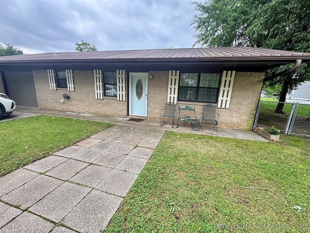 510 Beverly Ave, Vian, OK 74962 - view of front facade with a porch, brick siding, and metal roof