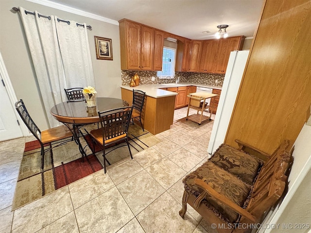 510 Beverly Ave, Vian, OK 74962 - kitchen with backsplash, freestanding refrigerator, light countertops, a peninsula, and brown cabinetry