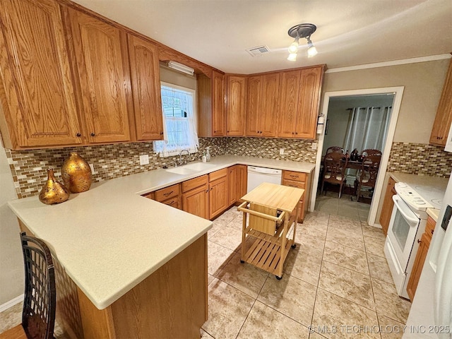 510 Beverly Ave, Vian, OK 74962 - kitchen featuring backsplash, white appliances, a peninsula, a sink, and light countertops