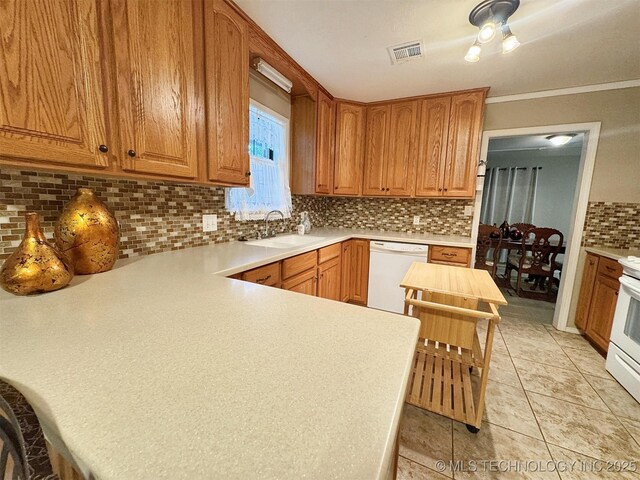 510 Beverly Ave, Vian, OK 74962 - kitchen with white appliances, a sink, tasteful backsplash, light countertops, and crown molding
