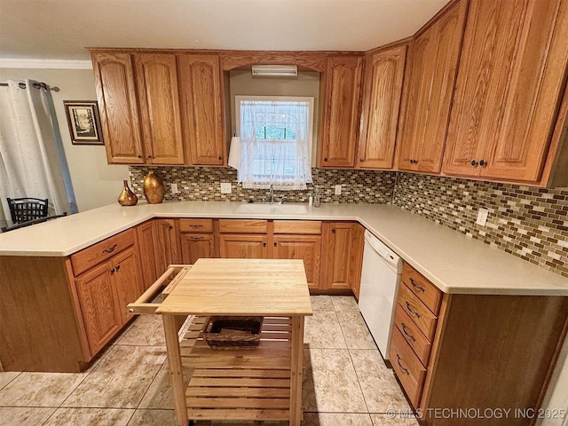510 Beverly Ave, Vian, OK 74962 - kitchen with a peninsula, white dishwasher, a sink, decorative backsplash, and crown molding
