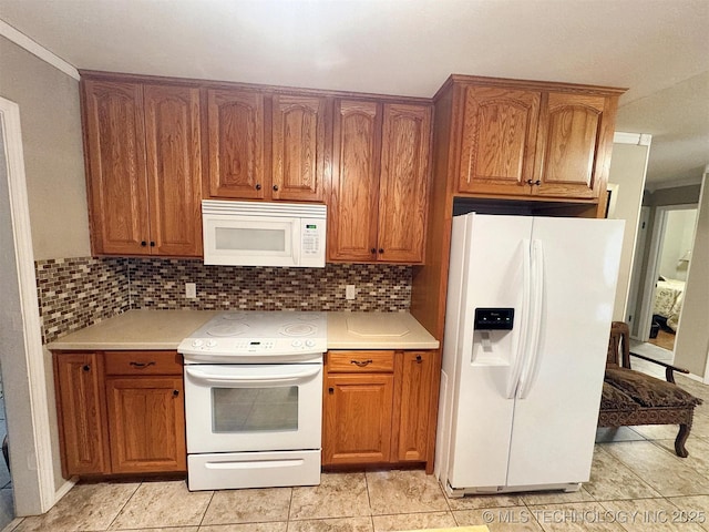 510 Beverly Ave, Vian, OK 74962 - kitchen featuring white appliances, brown cabinets, and crown molding
