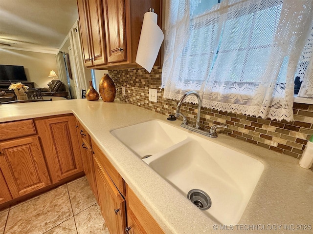 510 Beverly Ave, Vian, OK 74962 - kitchen with backsplash, a sink, and brown cabinetry