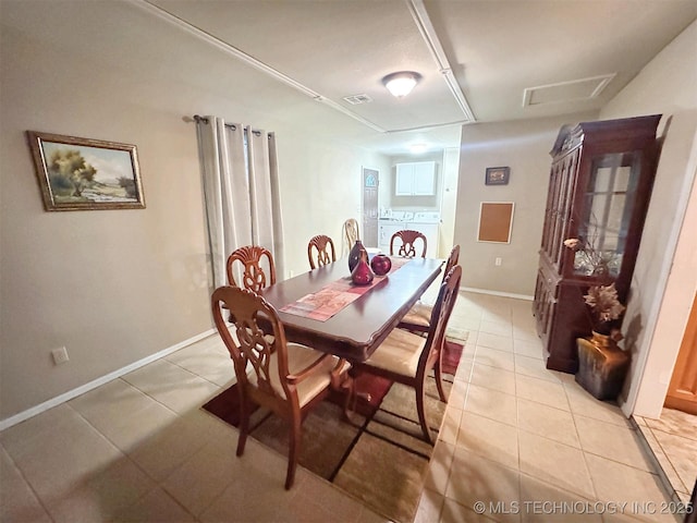510 Beverly Ave, Vian, OK 74962 - dining room with light tile patterned floors, baseboards, attic access, and separate washer and dryer