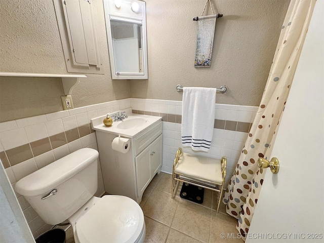 510 Beverly Ave, Vian, OK 74962 - bathroom with tile walls, tile patterned flooring, toilet, a wainscoted wall, and vanity