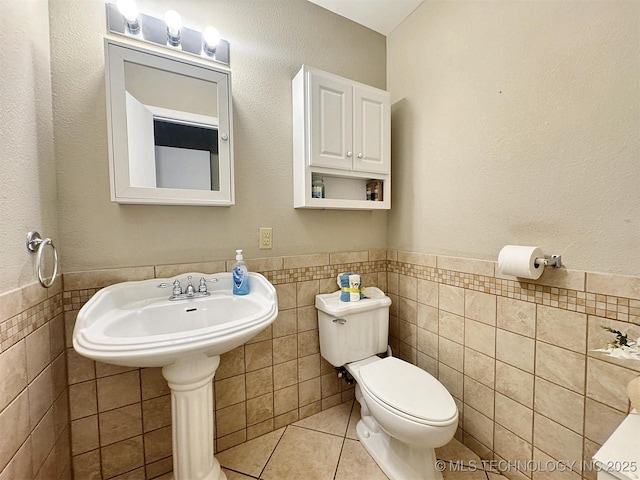 510 Beverly Ave, Vian, OK 74962 - half bathroom with tile walls, toilet, wainscoting, and tile patterned floors