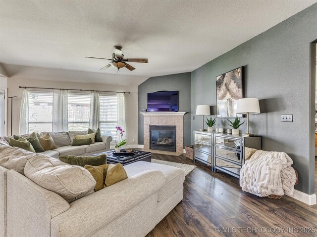 2008 N 8th St, Broken Arrow, OK 74012 - living room with a tile fireplace, ceiling fan, dark wood finished floors, a textured ceiling, and baseboards