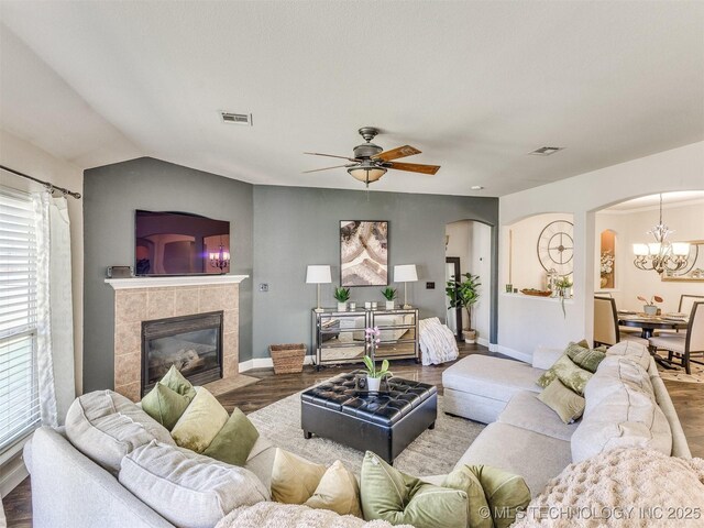 2008 N 8th St, Broken Arrow, OK 74012 - living room with arched walkways, wood finished floors, plenty of natural light, a tile fireplace, and lofted ceiling