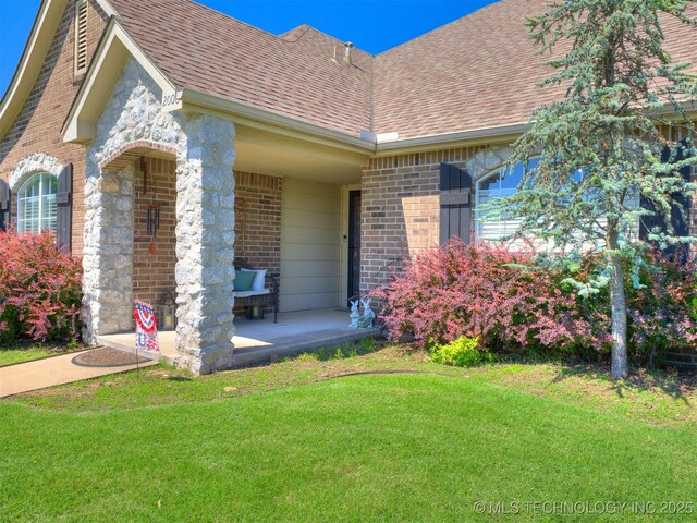 2008 N 8th St, Broken Arrow, OK 74012 - view of front facade featuring brick siding, a front yard, and a shingled roof