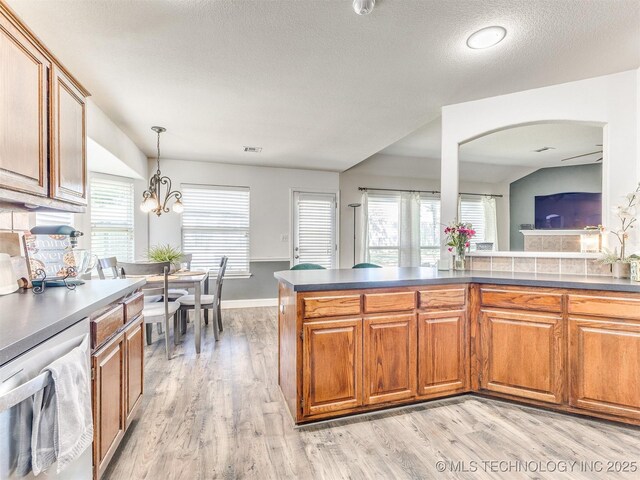 2008 N 8th St, Broken Arrow, OK 74012 - kitchen featuring stainless steel dishwasher, light wood-style flooring, brown cabinetry, plenty of natural light, and a textured ceiling
