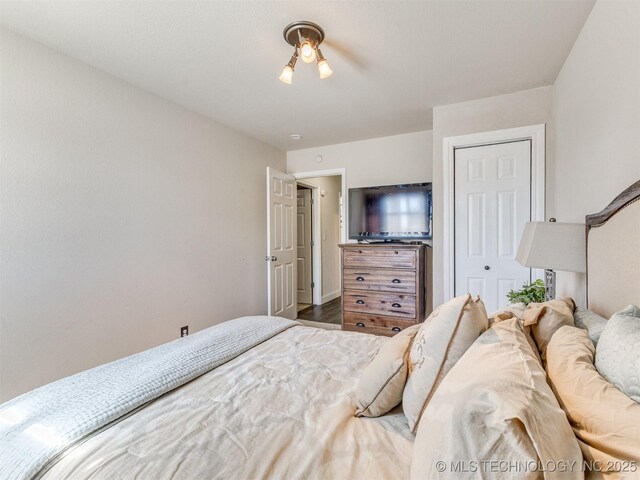 2008 N 8th St, Broken Arrow, OK 74012 - bedroom with a closet and wood finished floors