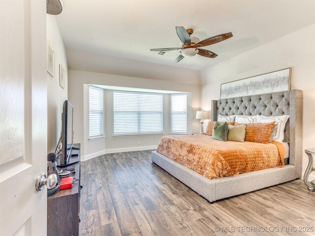 2008 N 8th St, Broken Arrow, OK 74012 - bedroom featuring wood finished floors, baseboards, and a ceiling fan