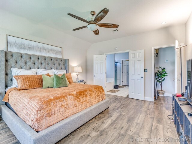 2008 N 8th St, Broken Arrow, OK 74012 - bedroom with wood finished floors, lofted ceiling, baseboards, ceiling fan, and ensuite bathroom