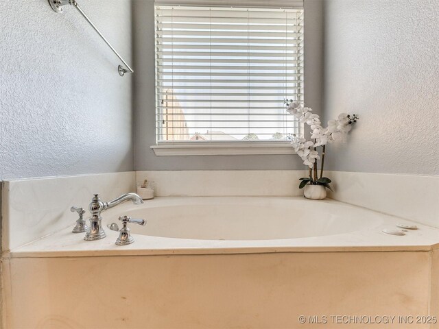 2008 N 8th St, Broken Arrow, OK 74012 - full bathroom with a textured wall and a bath