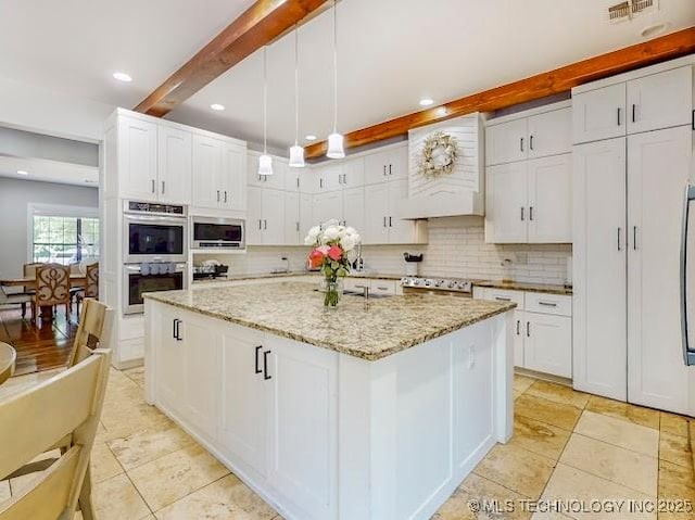 17716 S 39th W Ave, Mounds, OK 74047 - kitchen featuring appliances with stainless steel finishes, decorative backsplash, white cabinetry, beamed ceiling, and light tile patterned floors