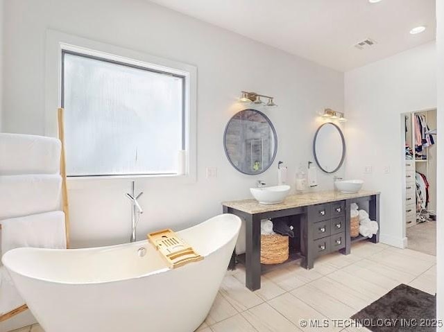17716 S 39th W Ave, Mounds, OK 74047 - full bath featuring double vanity, a freestanding bath, tile patterned flooring, and baseboards
