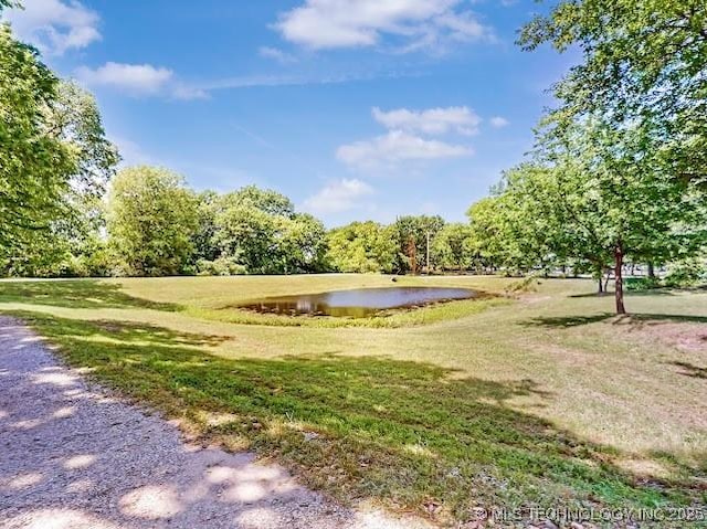 17716 S 39th W Ave, Mounds, OK 74047 - surrounding community with a water view and a lawn