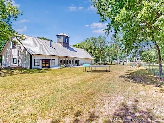 17716 S 39th W Ave, Mounds, OK 74047 - rear view of property with a trampoline and board and batten siding