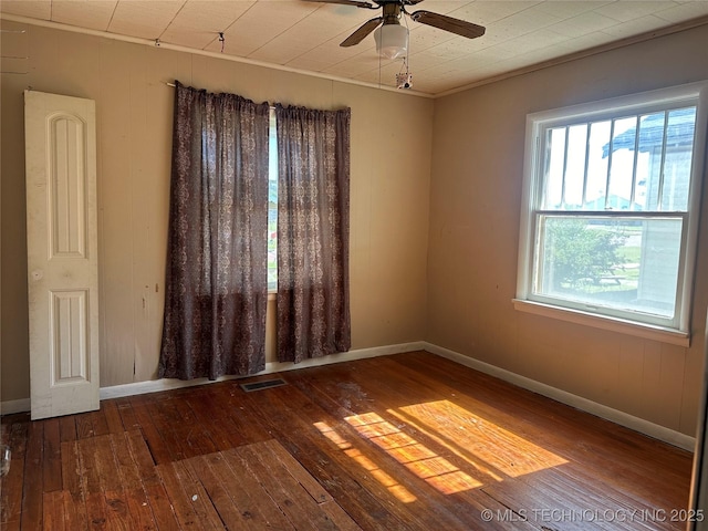 1107 W Broadway St, Henryetta, OK 74437 - empty room featuring hardwood / wood-style floors, baseboards, and a ceiling fan