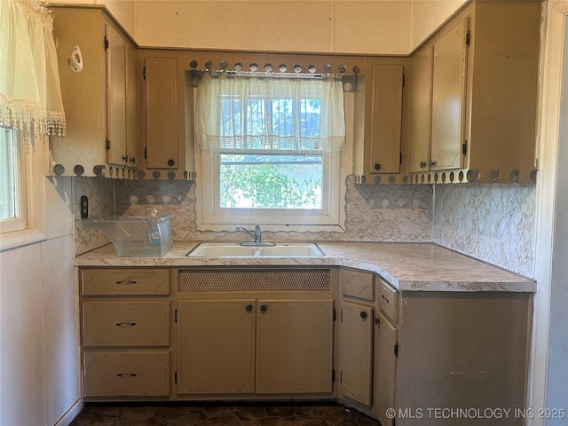 1107 W Broadway St, Henryetta, OK 74437 - kitchen featuring a sink, tasteful backsplash, and light countertops