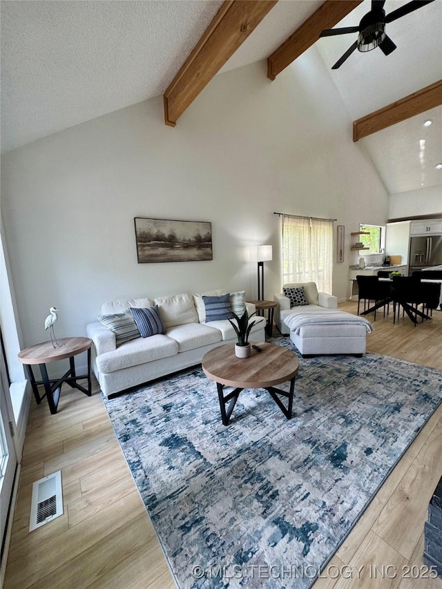 449734 E 356th Rd, Afton, OK 74331 - living area featuring beamed ceiling, ceiling fan, light wood-style floors, and high vaulted ceiling