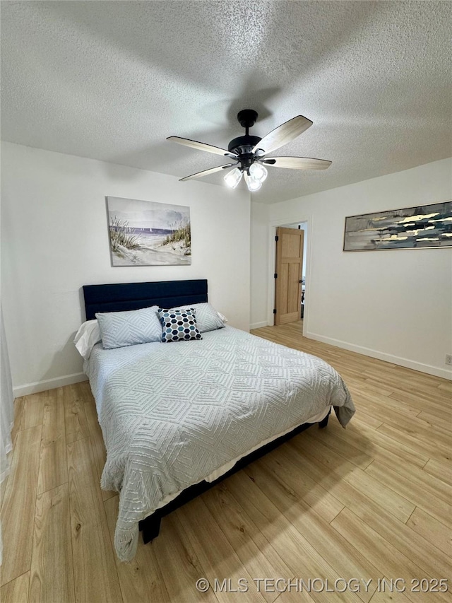 449734 E 356th Rd, Afton, OK 74331 - bedroom featuring light wood finished floors, baseboards, a textured ceiling, and ceiling fan