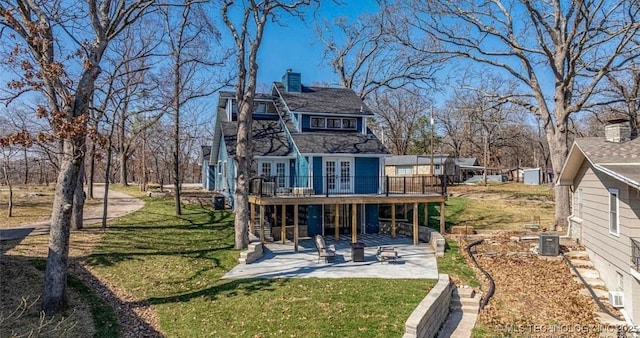 449734 E 356th Rd, Afton, OK 74331 - rear view of house with a patio, a lawn, a wooden deck, a chimney, and central AC unit