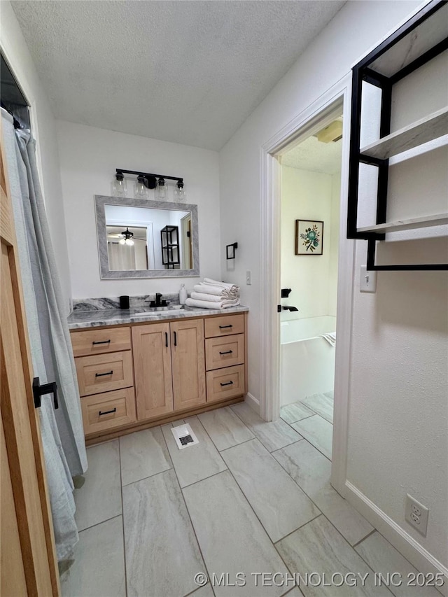 449734 E 356th Rd, Afton, OK 74331 - full bath featuring a textured ceiling, vanity, a bath, and baseboards